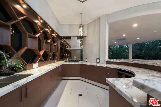 a kitchen with a sink and large window