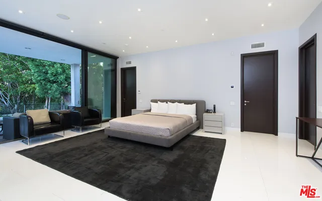 a bedroom with a large bed and a large window