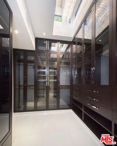 a bedroom with a large bed and a large window