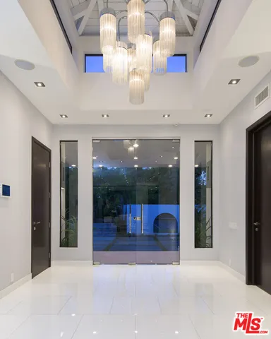 a view of lobby with livingroom and chandelier