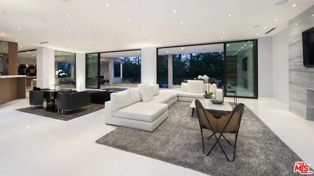 a living room with furniture and large window