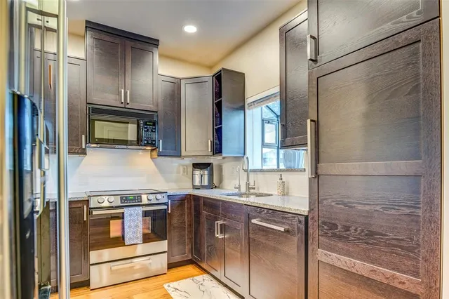 a kitchen with a refrigerator and a sink