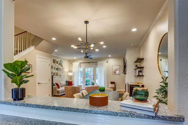a living room with furniture and a chandelier