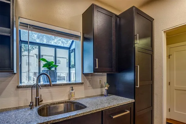 a kitchen with a sink and a refrigerator