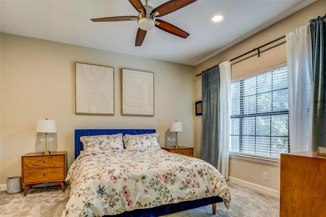 a bedroom with a large bed and a window