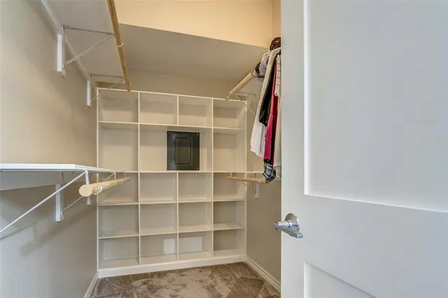a view of walk in closet with empty racks