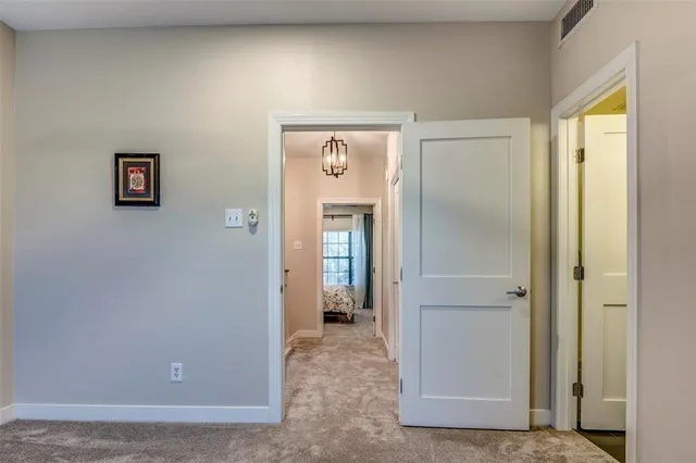 a view of a hallway with wooden floor and closet