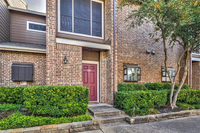 front view of a brick house with a large window