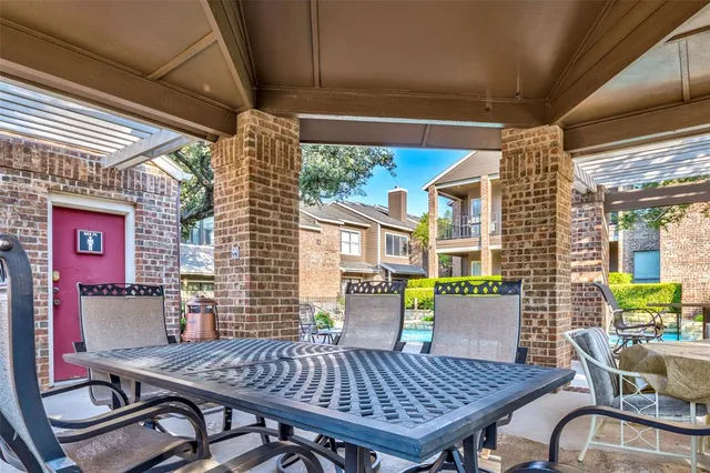a view of a dining table and chairs in patio