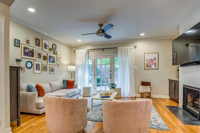 a living room with fireplace furniture and a flat screen tv