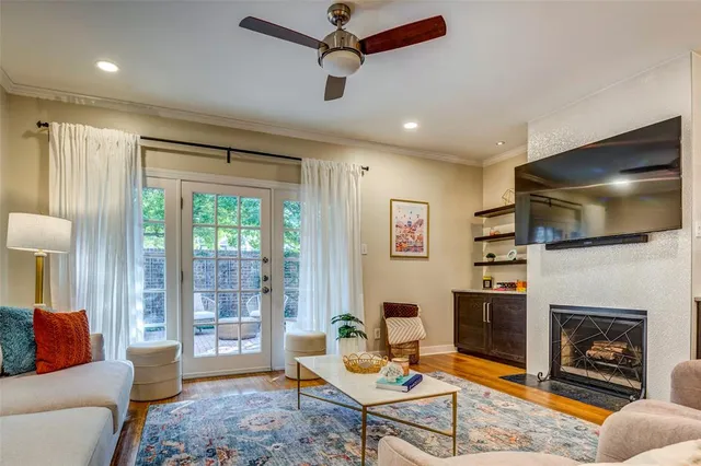 a living room with furniture a flat screen tv and a fireplace