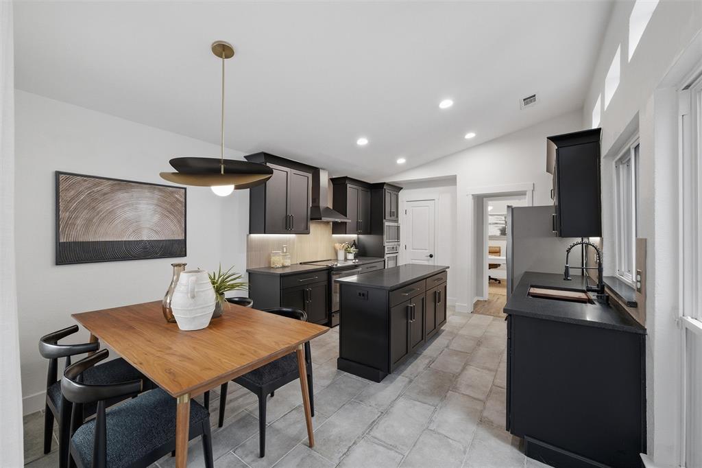 6029 Spring Flower Trail Dallas, TX 75248 - Photo 11 of 37 a kitchen with stainless steel appliances kitchen island granite countertop a sink a refrigerator and chairs