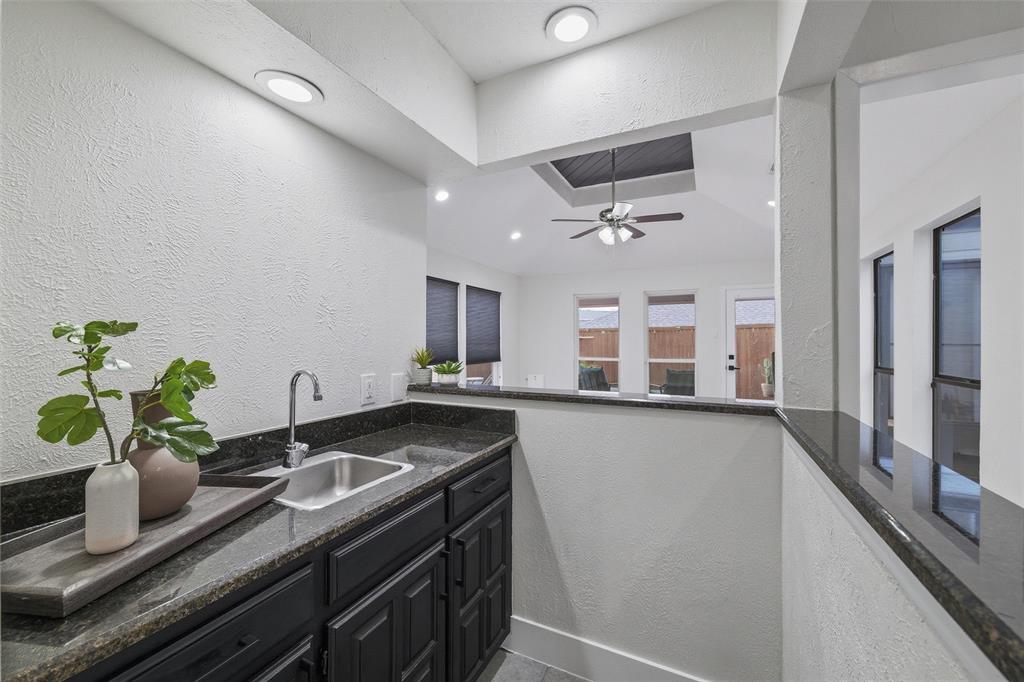 6029 Spring Flower Trail Dallas, TX 75248 - Photo 17 of 37 a kitchen with a sink and stove