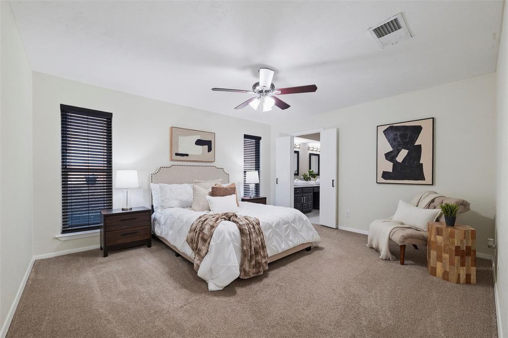 6029 Spring Flower Trail Dallas, TX 75248 - Photo 21 of 37 a bedroom with bed and a chandelier