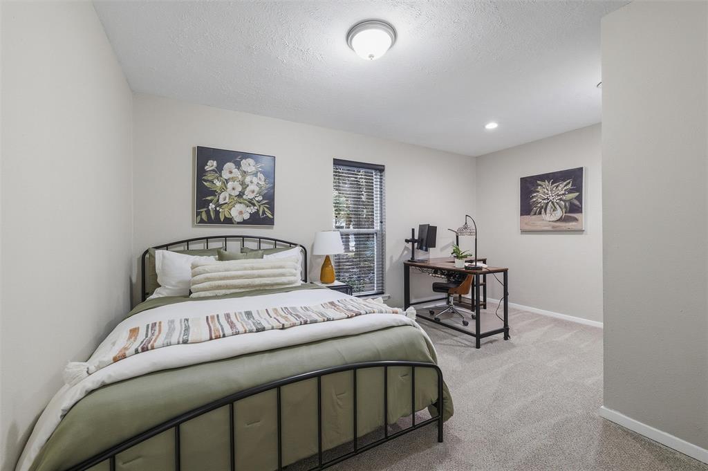 6029 Spring Flower Trail Dallas, TX 75248 - Photo 27 of 37 a bedroom with a bed and a table in it