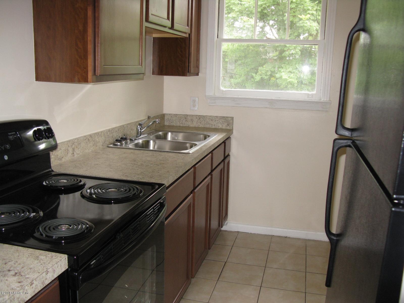 6641 Ector Road Jacksonville, FL 32211 - Photo 9 of 15 a kitchen with a stove and a sink