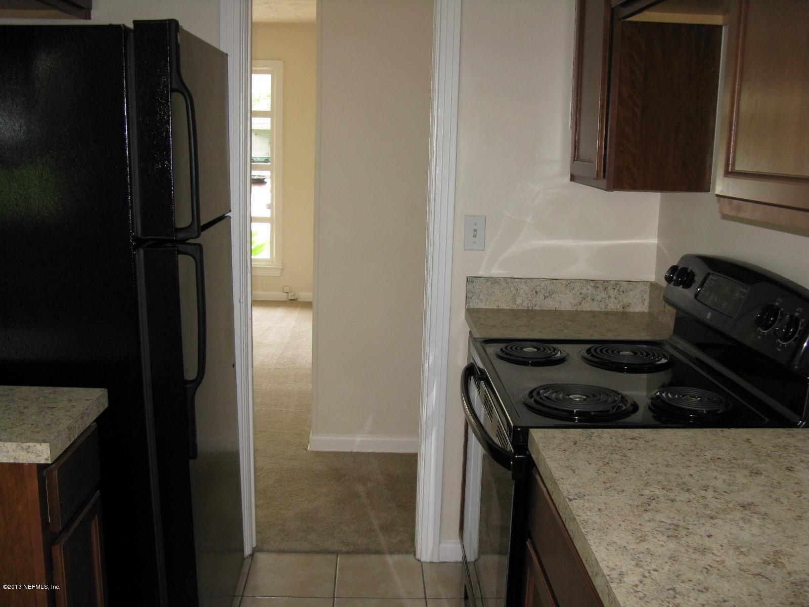 6641 Ector Road Jacksonville, FL 32211 - Photo 10 of 15 a kitchen with a stove and a refrigerator