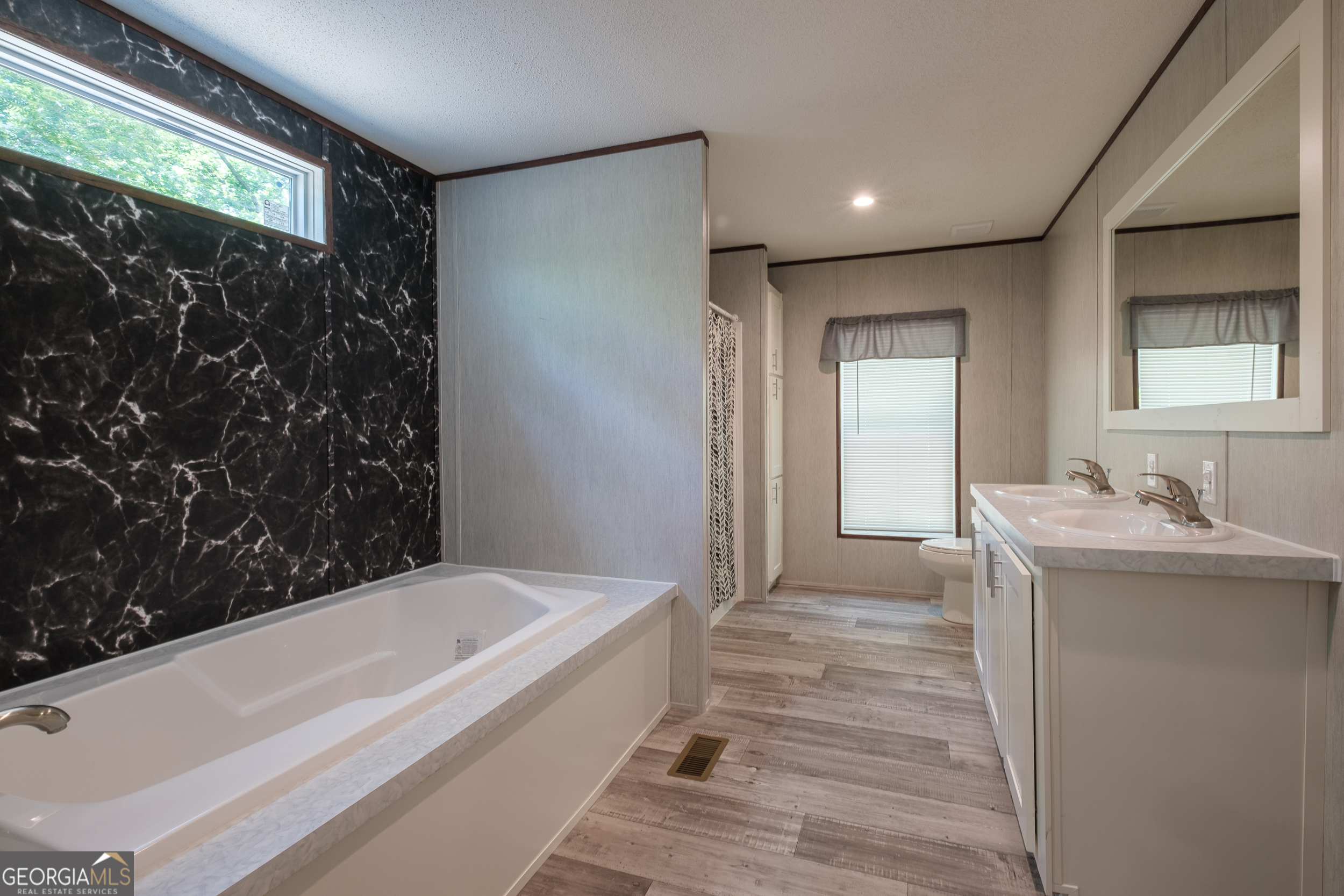2959 Lake Lannell Road Odum, GA 31555 - Photo 16 of 30 a bathroom with a granite countertop sink and a bathtub