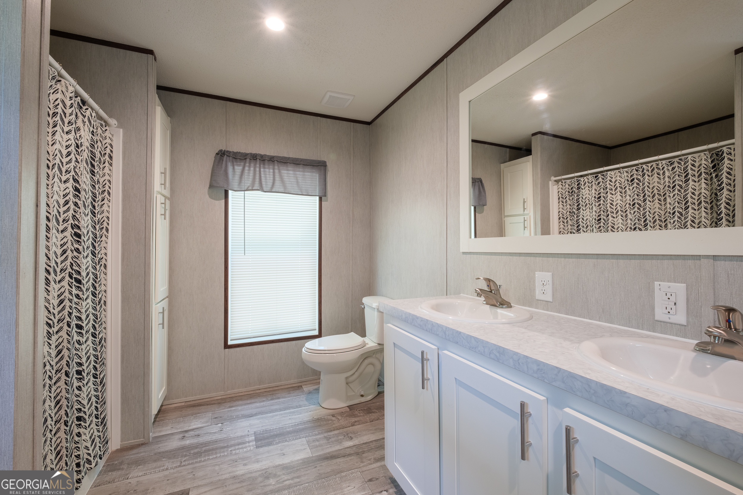 2959 Lake Lannell Road Odum, GA 31555 - Photo 17 of 30 a bathroom with a sink toilet a mirror and vanity