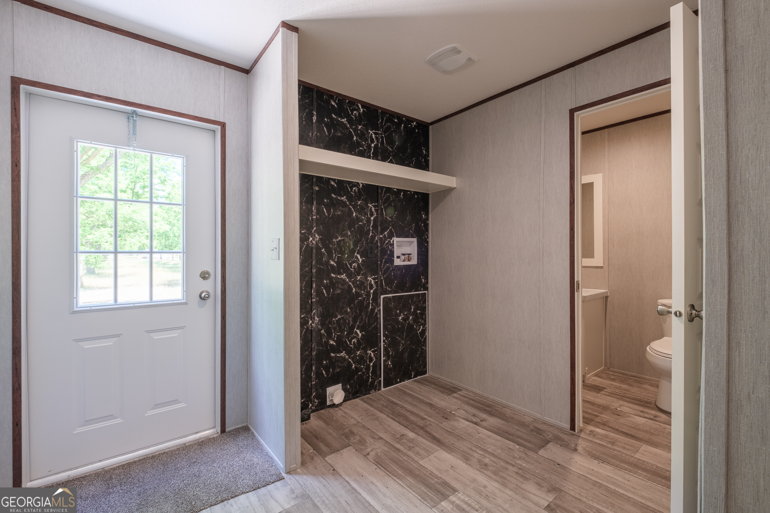 2959 Lake Lannell Road Odum, GA 31555 - Photo 19 of 30 an empty room with wooden floor closet and windows