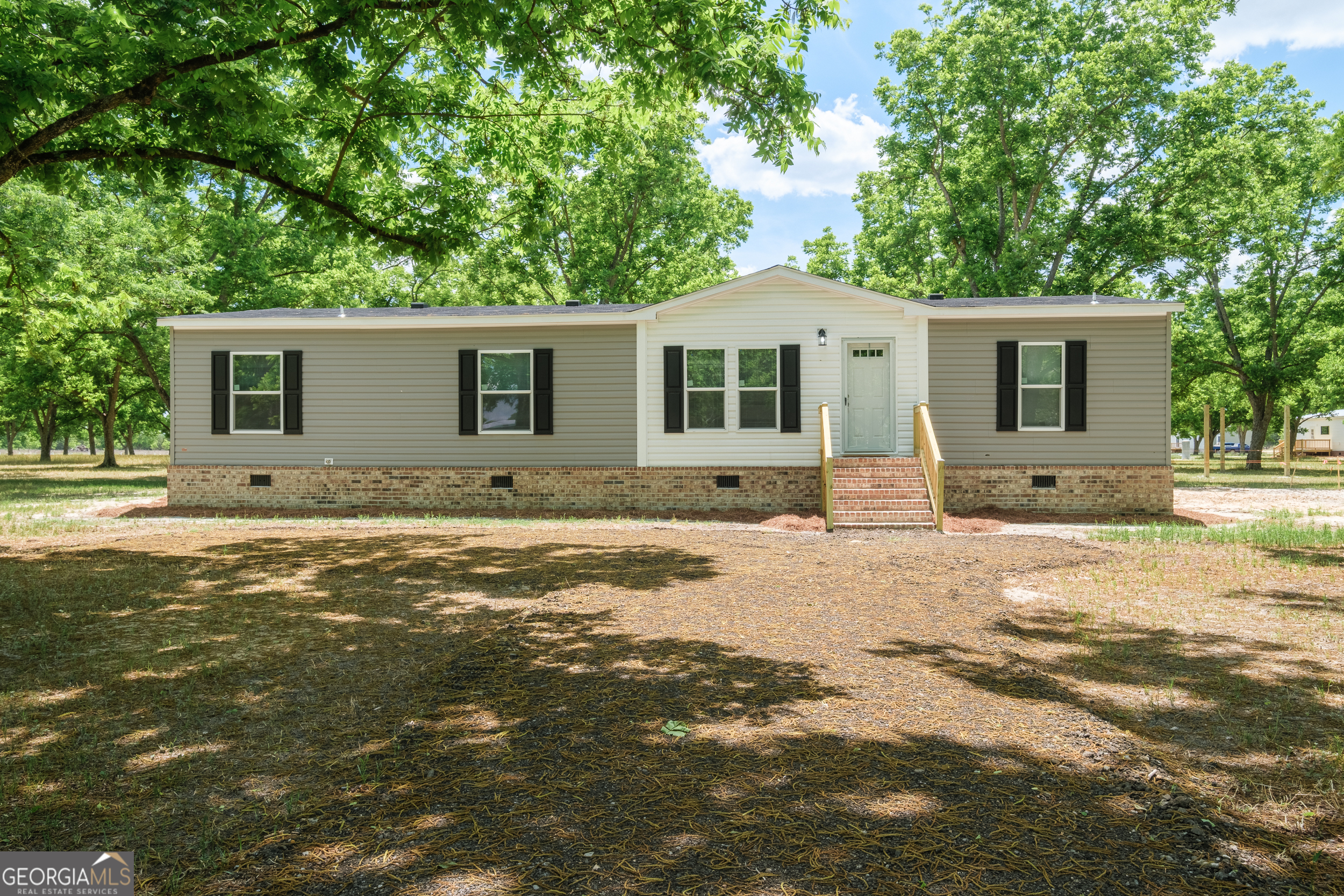 2959 Lake Lannell Road Odum, GA 31555 - Photo 2 of 30 a front view of a house with yard