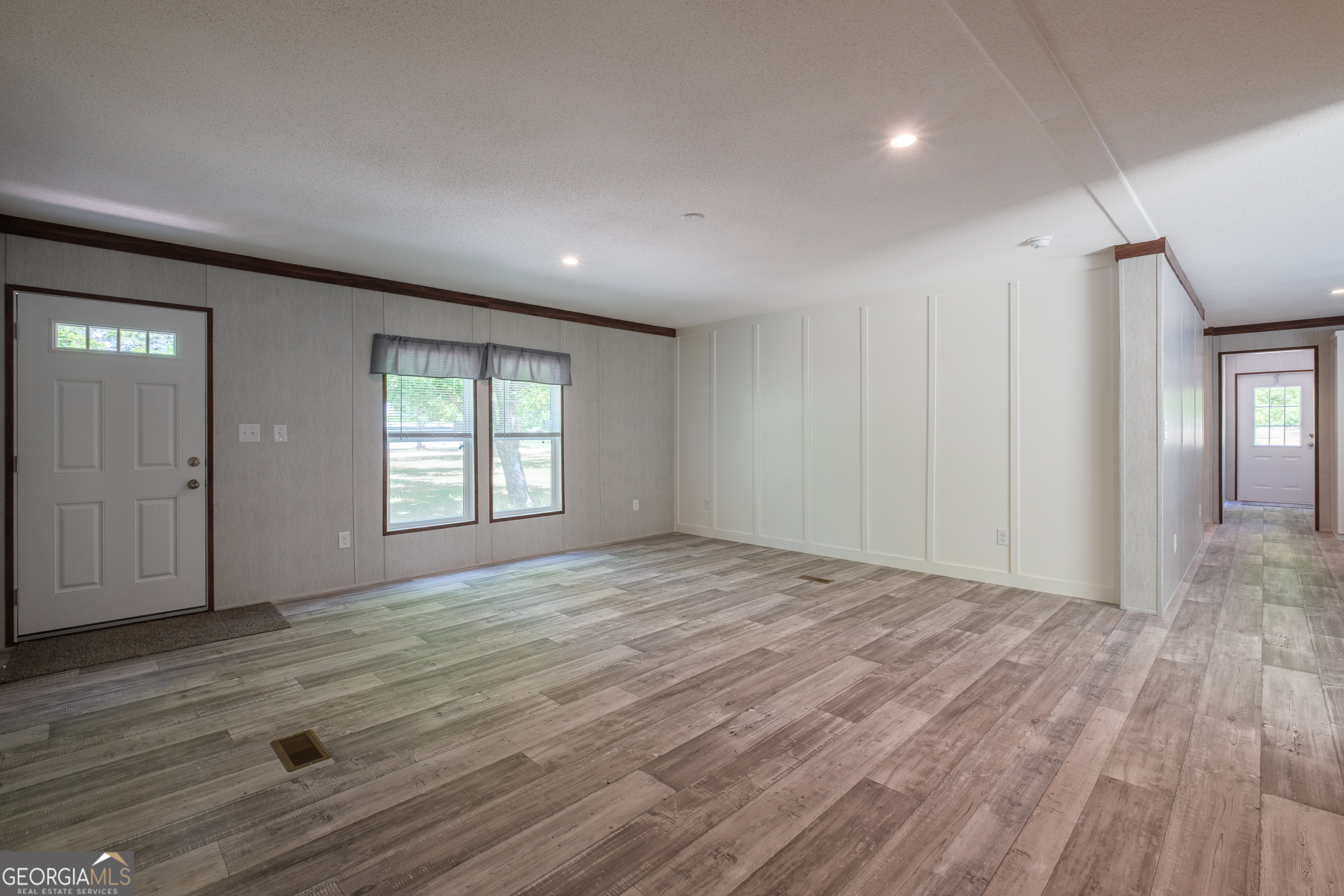 2959 Lake Lannell Road Odum, GA 31555 - Photo 7 of 30 a view of an empty room with wooden floor and a window