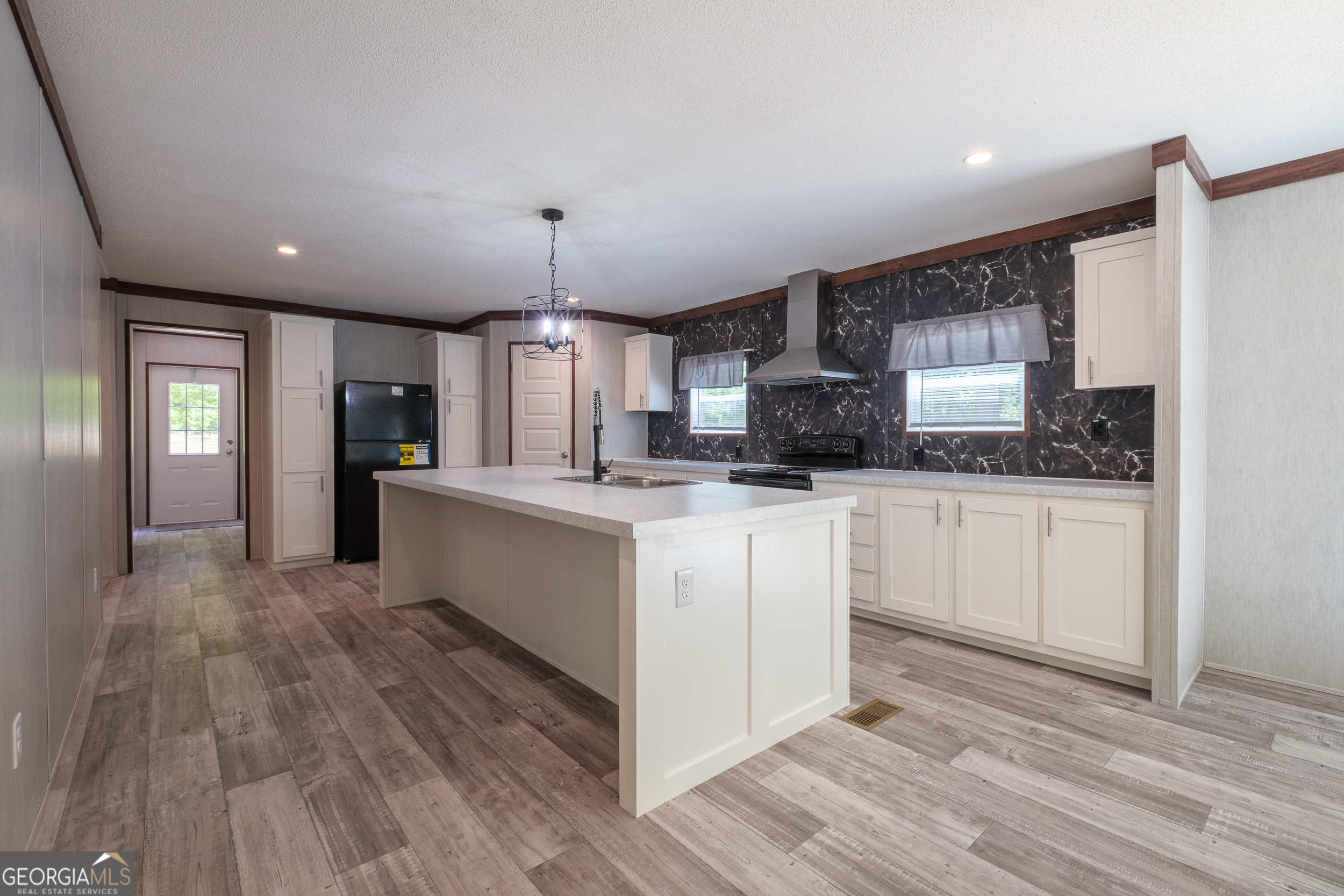 2959 Lake Lannell Road Odum, GA 31555 - Photo 8 of 30 a large kitchen with granite countertop a large counter top stainless steel appliances and cabinets