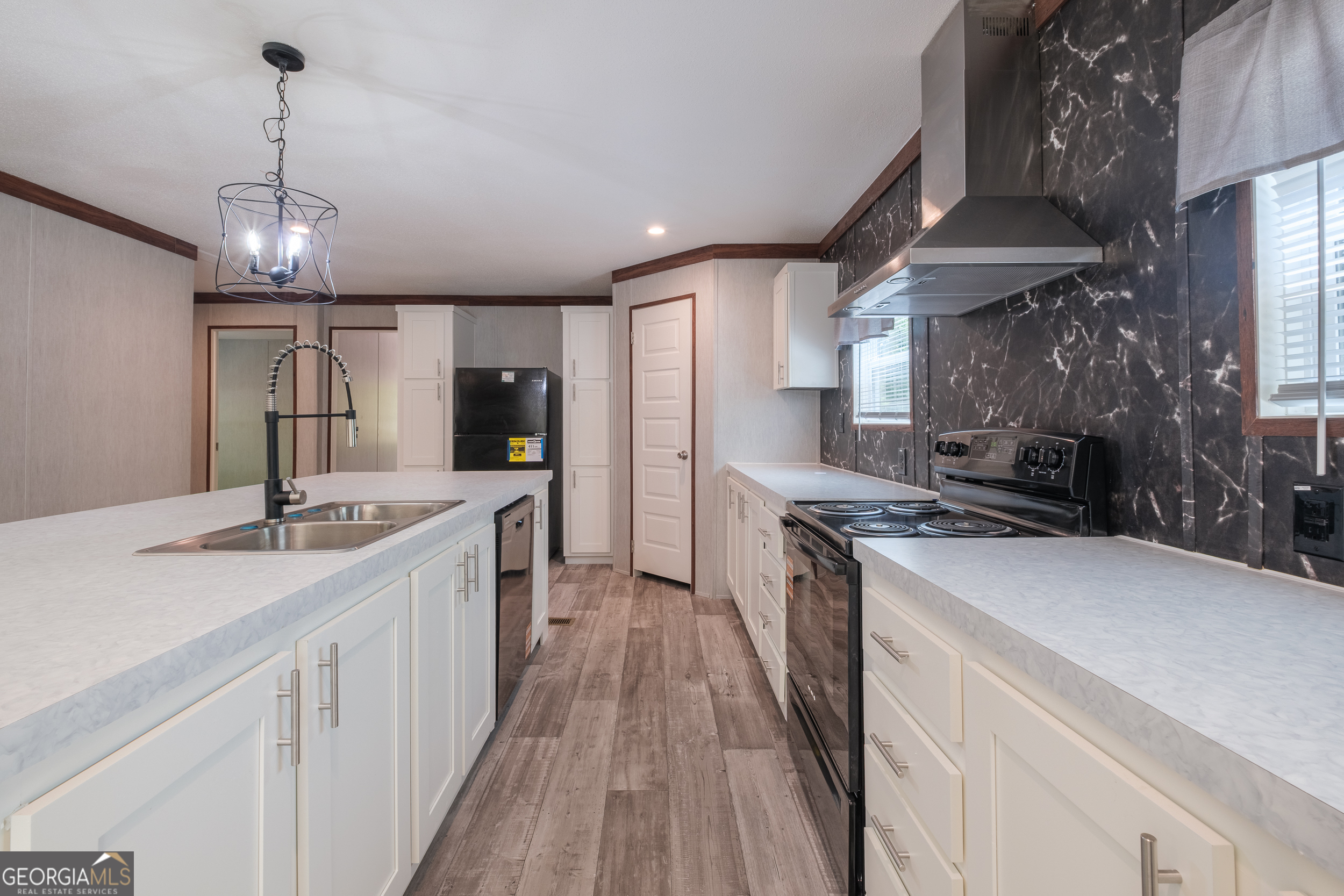 2959 Lake Lannell Road Odum, GA 31555 - Photo 10 of 30 a kitchen with stainless steel appliances granite countertop a sink stove and refrigerator