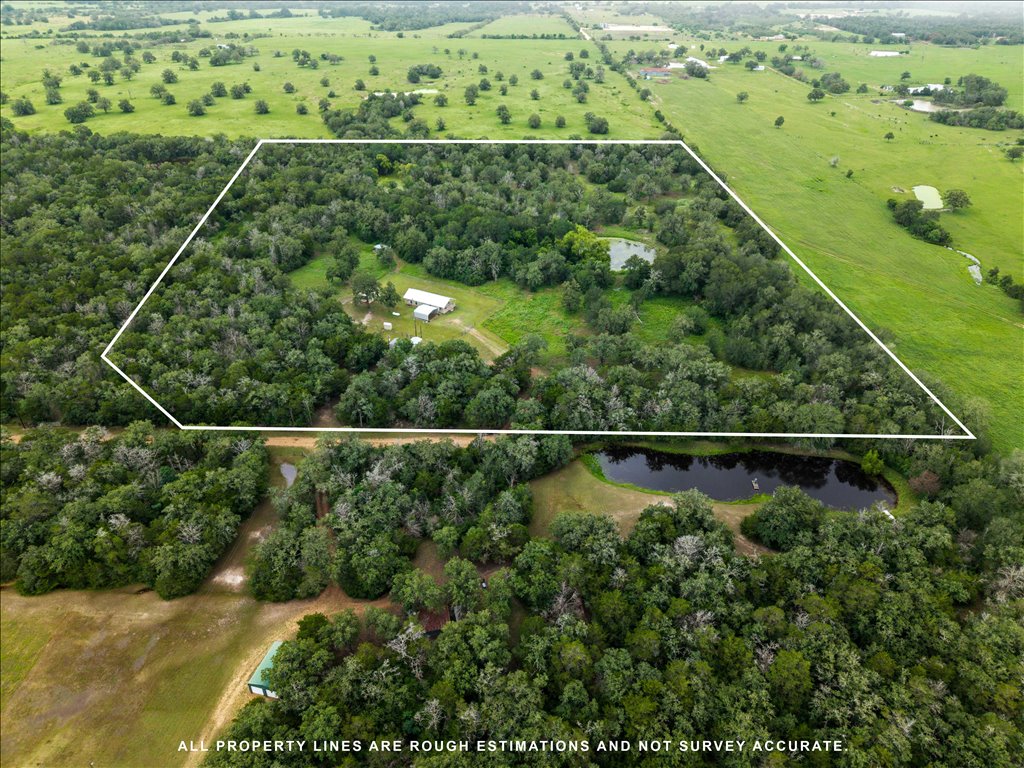 608 Whistleville Road Flatonia, TX 78941 - Photo 17 of 26 This view shows how the main home site is perfectly nestled into a cleared pocket, completely surrounded by a thick, protective perimeter of dense woods for ultimate privacy.