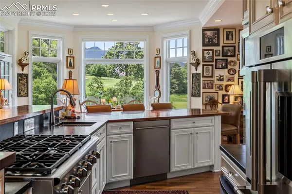 a kitchen with stainless steel appliances a stove sink and cabinets