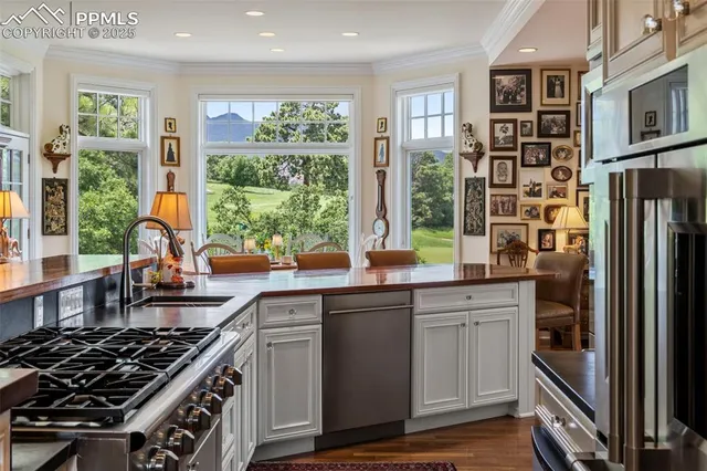 a kitchen with stainless steel appliances a stove sink and cabinets