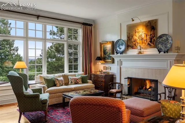 a living room with furniture a fireplace and a large window