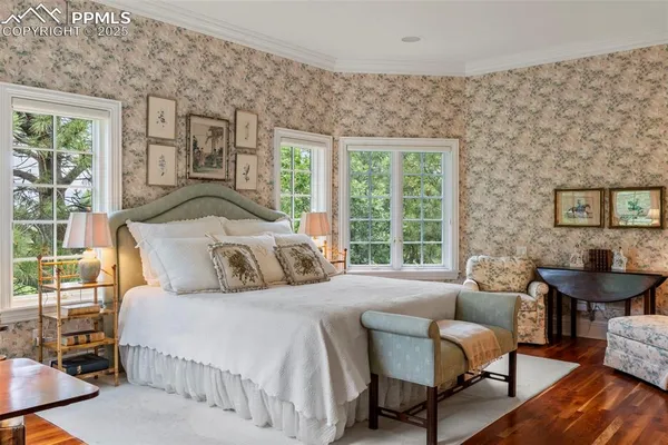 a bedroom with a bed a couch and dresser