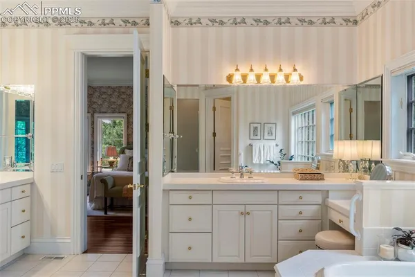 a bathroom with a double vanity sink and a mirror