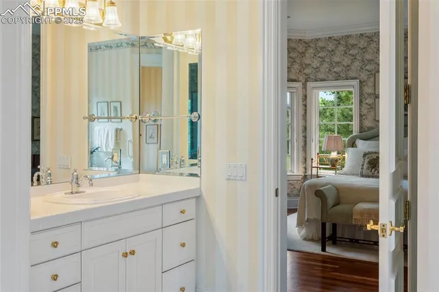 a en suite bathroom with a shower sink and mirror