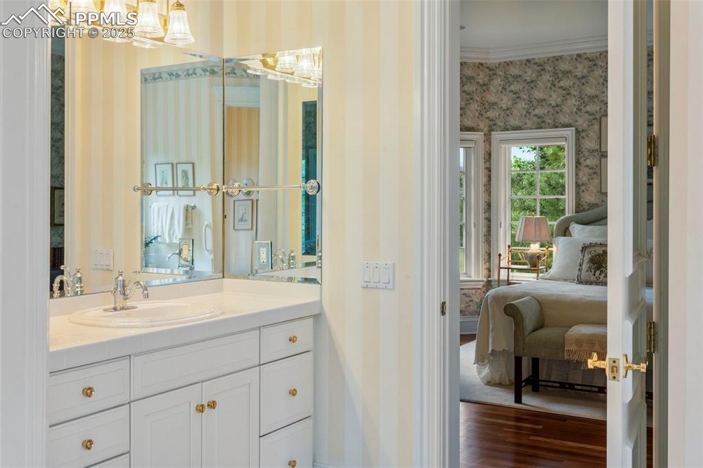 104 Marland Road Colorado Springs, CO 80906 - Photo 25 of 50 a en suite bathroom with a shower sink and mirror