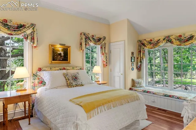 a bedroom with a large bed and a window