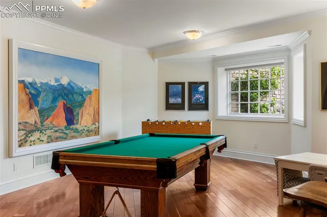 a room with furniture wall paintings and a window