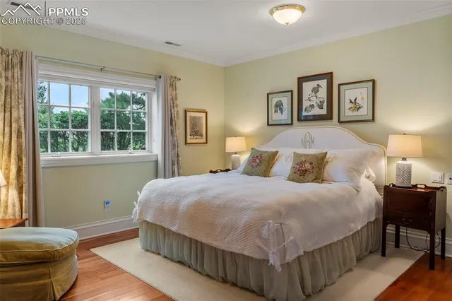 a bedroom with a bed and a lamp next to a window