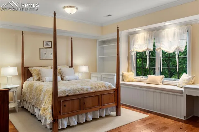 a bedroom with a bed window and a table