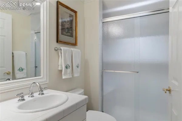 a bathroom with a sink toilet and mirror
