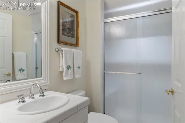 a bathroom with a sink toilet and mirror