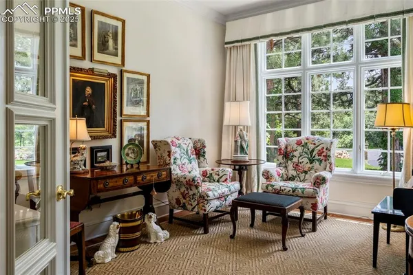 a living room with furniture a rug and a window