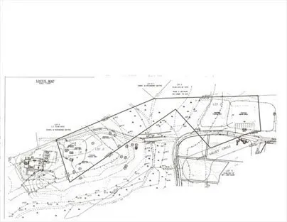 a view of a green field with trees in the background