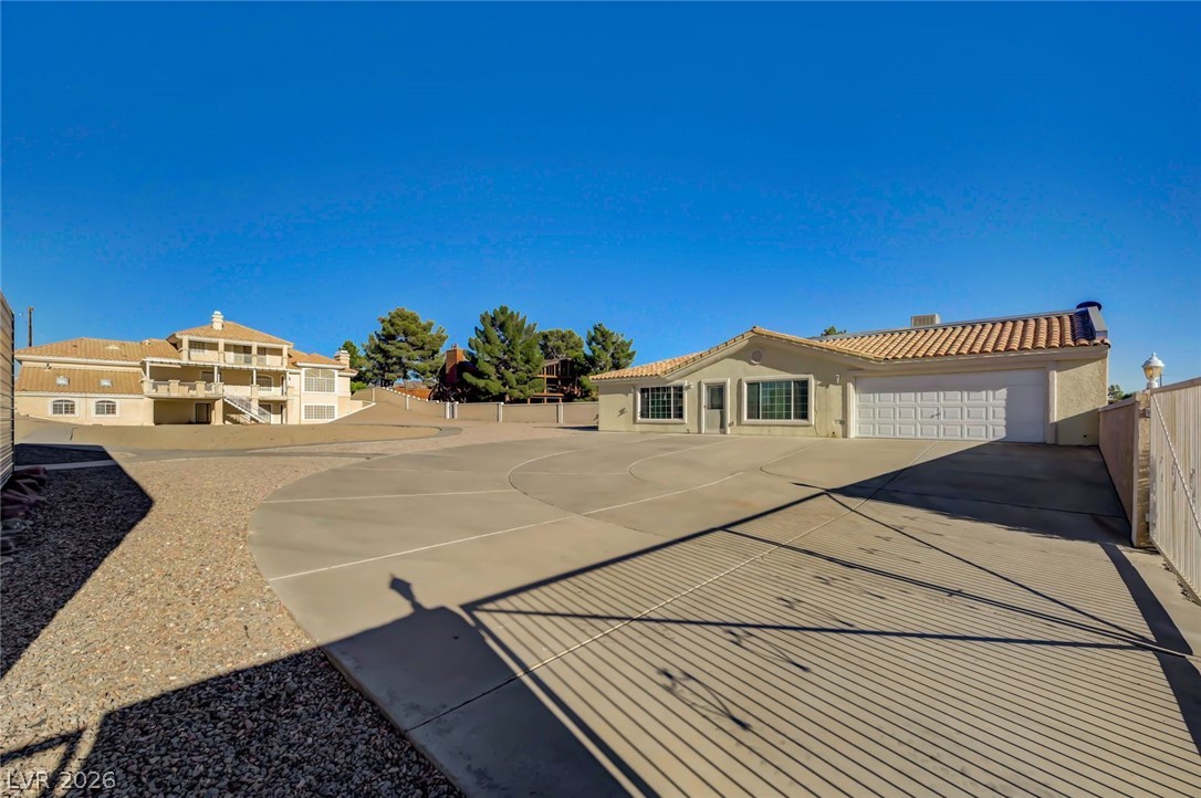 640 North Racetrack Road Henderson, NV 89015 - Photo 13 of 65 A spacious concrete driveway offers ample parking and leads to a welcoming home.