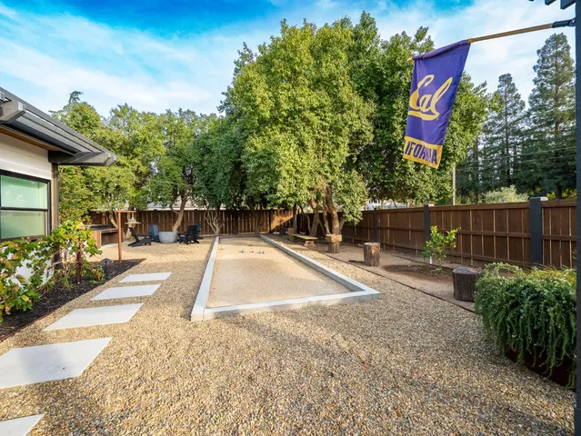 a view of a hallway with wooden floor and windows
