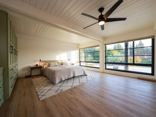 a spacious bedroom with a bed and a chandelier