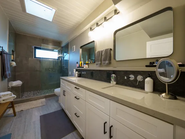 a bedroom with furniture and a large window