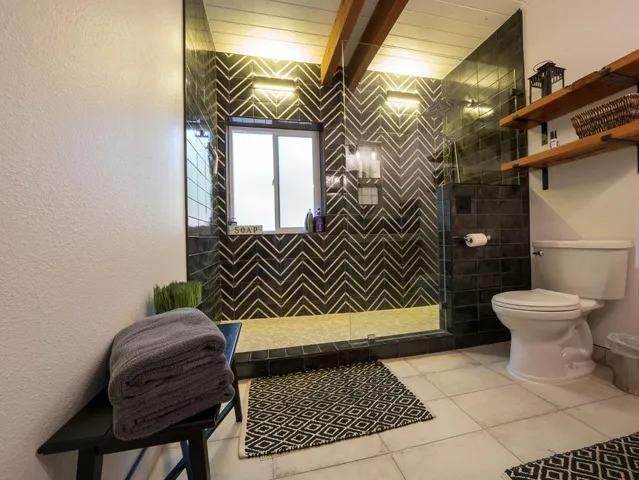 a bathroom with a glass shower door and a sink