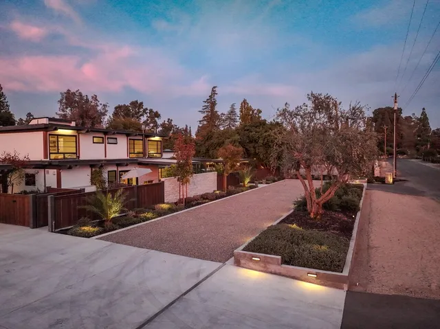 a view of a house with wooden fence